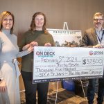 Three individuals stand side by side, holding a large ceremonial check from 'All Hands on Deck' for $37,500, dated February 9th, 2024, payable to SPCA St. John's for The Way Home Campaign.