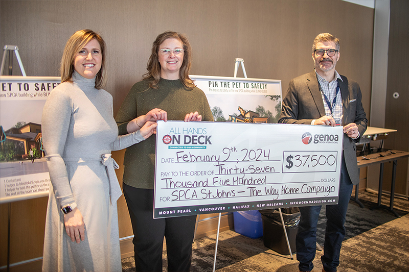 Three individuals stand side by side, holding a large ceremonial check from 'All Hands on Deck' for $37,500, dated February 9th, 2024, payable to SPCA St. John's for The Way Home Campaign.